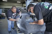 Topo from HPM Collision sands the fender of the Mustang.