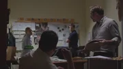 A group of detectives work in their office.