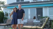 Homebuyers Anna Maria and Jim pose for a photo outside the Seawall House, as seen on HGTV's Beach Hunters.