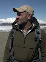 Close-up of Ed Stafford near frozen lake.