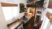 Newlyweds and tiny house owners Chris and Brianna have the perfect, custom tiny house that fits all of their needs with a cozy bedroom loft, spacious dining area and gooseneck living room, as seen on Tiny House, Big Living.