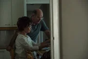 Bev (ADRIENNE PIERCE) goes trough the family finances. Doug (DEONS LOTZ) gives her a cheque.