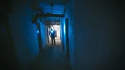 FBI agent holding a gun and investigating spooky surroundings