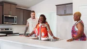 From left to right: Host David Bromstad, Charman Morgan-Davis, and Morgan Davis explore the kitchen of House 3, Queen's Landing, as seen on My Lottery Dream Home, Season 17. From left to right: Host David Bromstad, Charman Morgan-Davis, and Morgan Davis explore the kitchen of House 3, Queen's Landing, as seen on My Lottery Dream Home, Season 17.