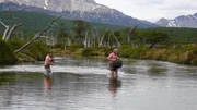 Cody Lundin and Dave Canterbury crossing a river.