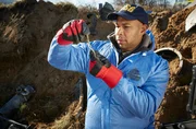 REENACTMENT - An NTSB Investigator (played by a background performer) examines a key piece of wreckage found deep in the impact crater of the plane crash that killed world famous golfer Payne Stewart. (Photo Credit: Cineflix/Ian Watson) REENACTMENT - An NTSB Investigator (played by a background performer) examines a key piece of wreckage found deep in the impact crater of the plane crash that killed world famous golfer Payne Stewart. (Photo Credit: Cineflix/Ian Watson)