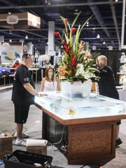 Wayde King and Brett Raymer install the tank into the table top.
