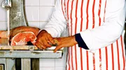 Mid section of a butcher at a shop Mid section of a butcher at a shop