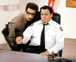 L-R:  Lt. Proctor (Lance Kinsey) and Commandant Mauser (Art Metrano)