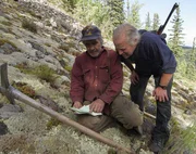 Mike McCann (L) and Stan Zuray (R) deciphering a map of their mining site at Quartz Creek.