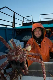 Summer Bay engineer, Tim Boles sorts large crab with deckhand, Kyle Craig.
