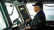 Captain Harley at the helm of the Southern Wind.