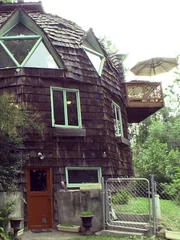 The exterior of the first home which is in the shape of a dome and is more energy efficient than a standard home because its walls have a smaller surface area. BUYING ALASKA, S03a.