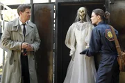 BONES: Booth (David Boreanaz, L) and Brennan (Emily Deschanel, R) examine a skeleton found at the scene of a fire in the BONES episode "The Witch in the Wardrobe".
