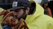Time Bandit deckhand Jared Porter kissing crab.