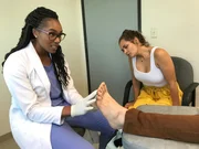 Dr. Vincent looks up at Paul Wright while explaining something during his consultation. Paul’s girlfriend Lauren looks at Paul’s foot in the background. Dr. Vincent looks up at Paul Wright while explaining something during his consultation. Paul’s girlfriend Lauren looks at Paul’s foot in the background.