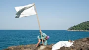 Cody raising a flag to signal rescue. Cody raising a flag to signal rescue.