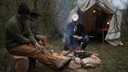 L-R: Matt, Misty and Marty Raney sit outside of their tent.