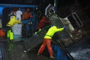 Seen from the wheelhouse, the crew of the Summer Bay hauls gear.