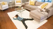 Five year old Julian Silva spreads out on the new rug in his updated living room, as seen on Fixer Upper. (after, action)