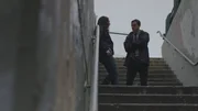 Detective Strovink talks to a prostitute in the stairwell.