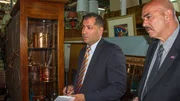 Detectives interview Margaret at the antique shop.