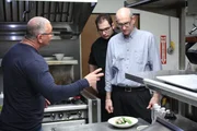 Host Robert Irvine prepares to teach Tasso and his son, Phillip some new recipes for his men.