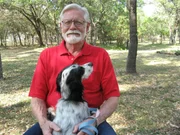 Derek Berry with English Setter on lap.