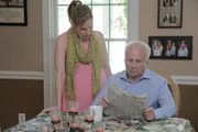 Paul Carpenter reads the newspaper as Jana looks over his shoulder.
