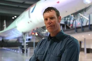 Wide angle view of Sean standing in front of the Concorde