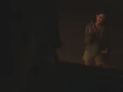 Killer looking through truck's window at Sara waving.