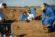 REENACTMENT - NTSB Investigators (played by background performers) set up a grid to chart the location of key pieces of wreckage at the site of world famous golfer Payne Stewart's fatal plane crash.