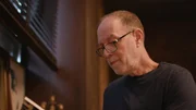Bill Adler with glasses on reading a book Bill Adler with glasses on reading a book