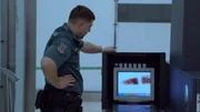 Border officer inspects the x-ray records.