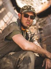 Kevin in a crouching pose inside a piece of equipment.