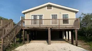 Tan Lines is a cute beach house in Gulf Shores, Alabama featuring a large deck space and space to park cars and boats as seen on HGTV's Beachfront Bargain Hunt.