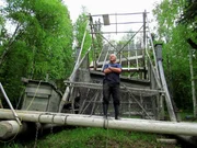 Stan Zuray standing on his fishing mechanism.