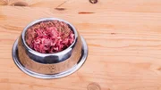 Fresh nutritious and delicious minced raw meat and bone dog food in bowl