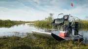 Air boat on bank of creek Air boat on bank of creek