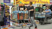 Joyce and her son with full carts.