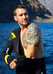 Brandon puts on diving suit.