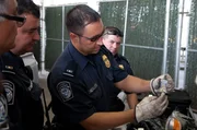 Laredo, TX: Customs and Border Protection agents testing the smuggled substances found in a car to determine if they are cocaine.