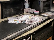 Cashier with a stack of coupons Cashier with a stack of coupons