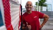 Ep2 - Massimo is standing in front of his truck, arms crossed, close