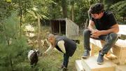 Jon and Krsitina play with a goat on the farm while renovating a 100 year old home as seen on HGTV's Farmhouse Fixer.