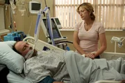 Medium shot in hospital room, of James Gandolfini as Tony Soprano, eyes closed, laying in bed with tubes attached to mouth and nose, and a worried Edie Falco as Carmela Soprano standing by bedside holding his hand. (Episode #602) Medium shot in hospital room, of James Gandolfini as Tony Soprano, eyes closed, laying in bed with tubes attached to mouth and nose, and a worried Edie Falco as Carmela Soprano standing by bedside holding his hand. (Episode #602)