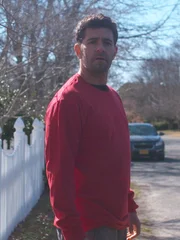 The mysterious man in the red shirt stalks past Randy's house.
