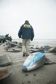 REENACTMENT - NTSB-Ermittler Tom Haueter (gespielt von Christian Lloyd) untersucht die Trümmer zweier Flugzeuge, die nach einem tödlichen Zusammenstoß auf dem Quincy Regional Airport verstreut wurden. REENACTMENT - NTSB-Ermittler Tom Haueter (gespielt von Christian Lloyd) untersucht die Trümmer zweier Flugzeuge, die nach einem tödlichen Zusammenstoß auf dem Quincy Regional Airport verstreut wurden.