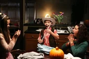 Tim O'Bryan (Connor McGee) is excited about his pixie stick. Deb O'Bryan (Gail Hafar) and Elizabeth O'Bryan (Kimberly Kashner) look on.