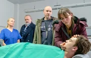 Im Beisein von Hauptkommissar Richard Voss (Jan-Gregor Kremp, 2.v.l.) und der Gerichtsmedizinerin Dr. Franziska Sommerfeld (Christina Rainer, l.) nehmen Bernd Rotthoff (Paul Herwig, 2.v.r.) und seine Frau Stefanie Rotthoff (Kathrin von Steinburg, r.) in der Rechtsmedizin Abschied von ihrem Sohn Maik Rotthoff (Manuel Kandler, vorne).